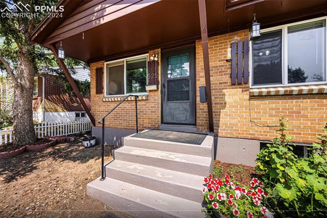 525 Yellowstone Road Colorado Springs, CO 80910 - Photo 2 of 8 View of exterior entry with covered porch