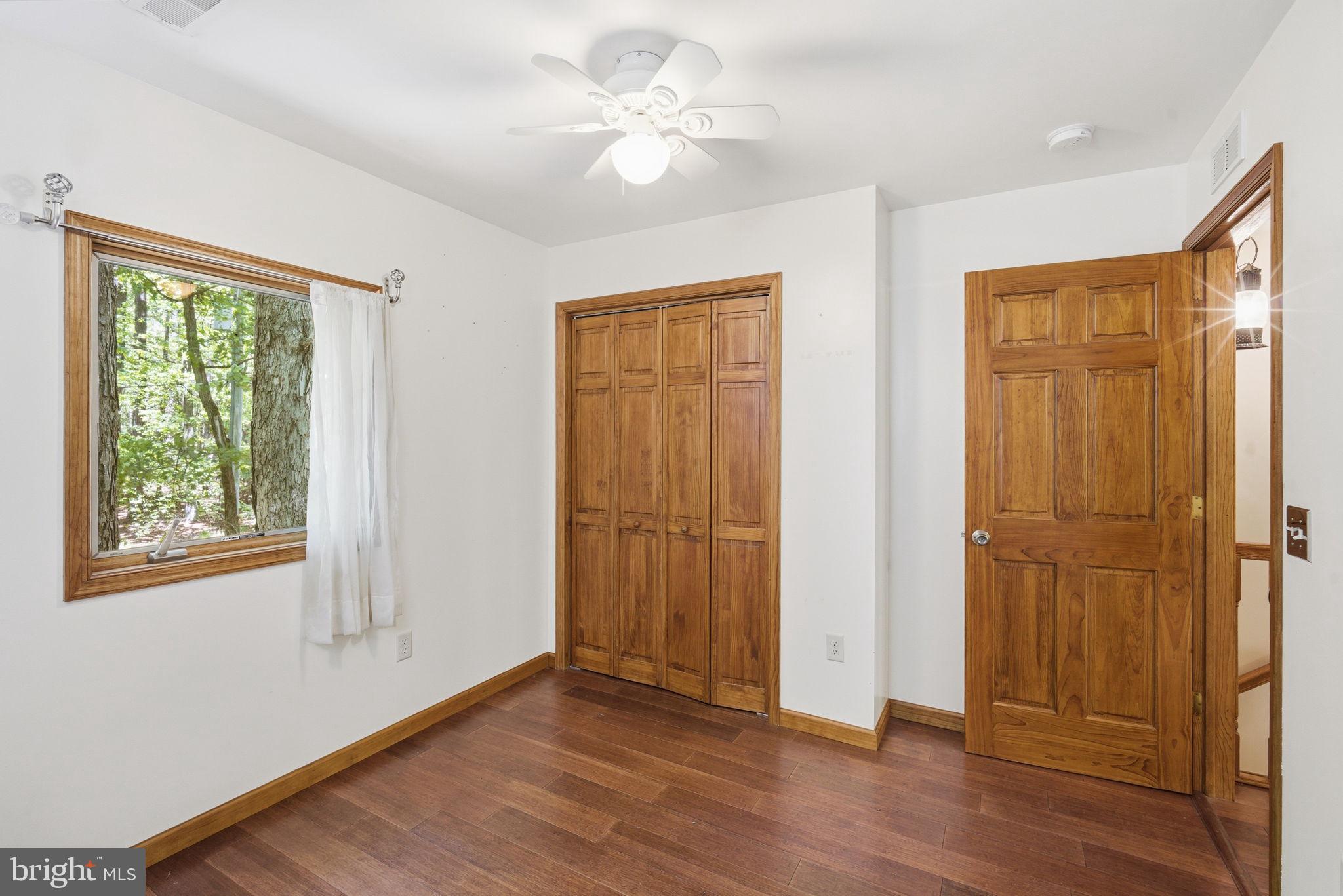 22300 Frazier Road Rock Hall, MD 21661 - Photo 19 of 38 a view of an empty room with wooden floor and a window