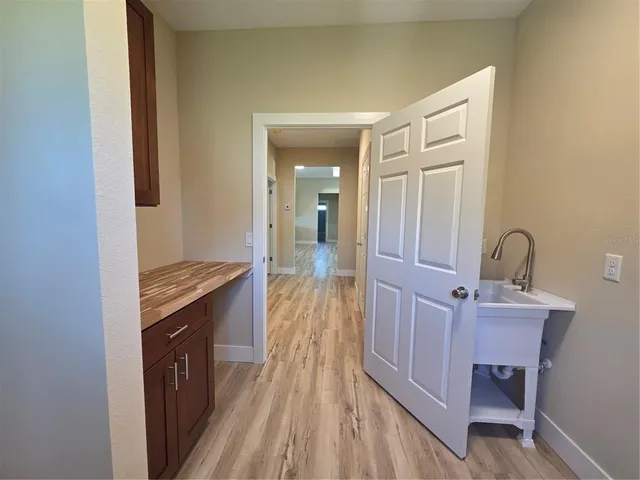 a view of a room with wooden floor