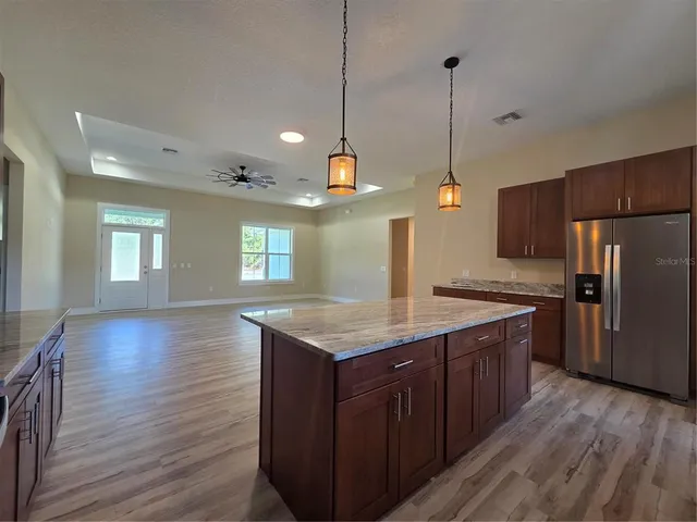 a kitchen with wooden floors and wooden cabinets