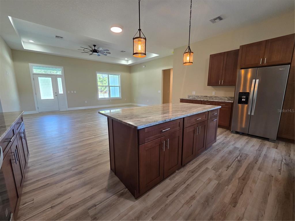 8005 North Terrel Point Citrus Springs, FL 34434 - Photo 21 of 41 a kitchen with wooden floors and wooden cabinets