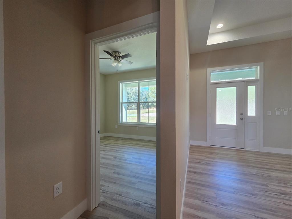 8005 North Terrel Point Citrus Springs, FL 34434 - Photo 22 of 41 wooden floor in a hall with a window