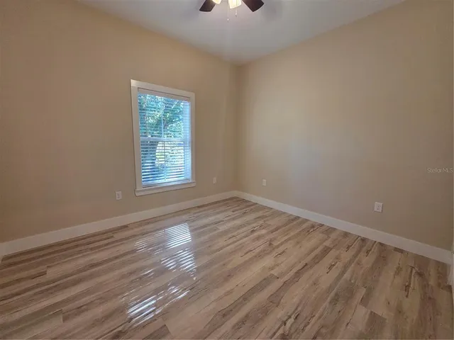 a view of an empty room and wooden floor