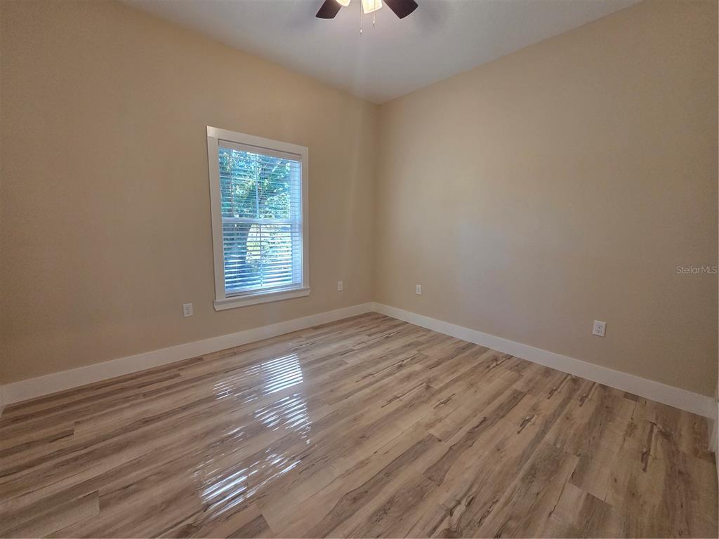 8005 North Terrel Point Citrus Springs, FL 34434 - Photo 27 of 41 wooden floor in an empty room with a window