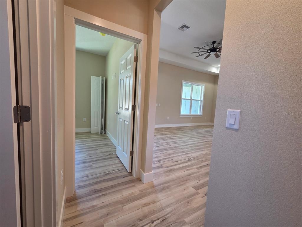 8005 North Terrel Point Citrus Springs, FL 34434 - Photo 30 of 41 a view of a hallway with wooden floor and a bathroom