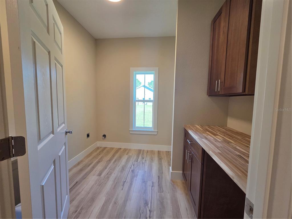 8005 North Terrel Point Citrus Springs, FL 34434 - Photo 10 of 41 a view of an empty room with wooden floor and a window