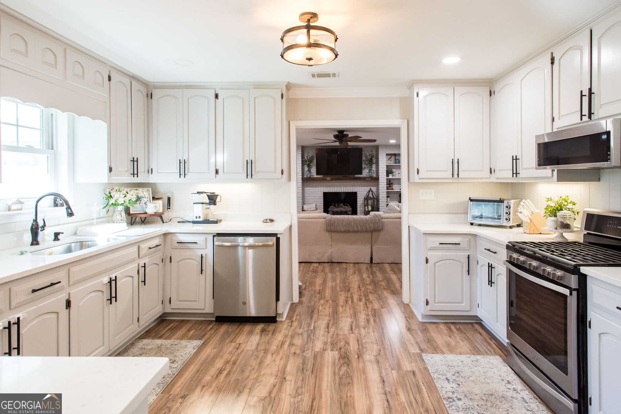 6737 Hacklebarney Road Blackshear, GA 31516 - Photo 11 of 40 a kitchen with white cabinets stainless steel appliances and sink