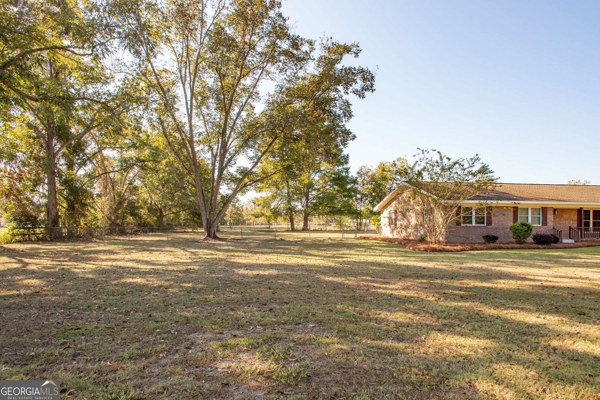 6737 Hacklebarney Road Blackshear, GA 31516 - Photo 38 of 40 a view of a big room with a big yard and large trees