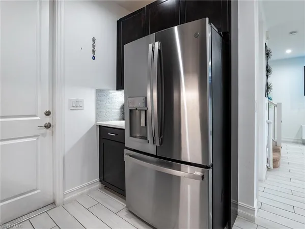 a view of a kitchen with a sink and a refrigerator