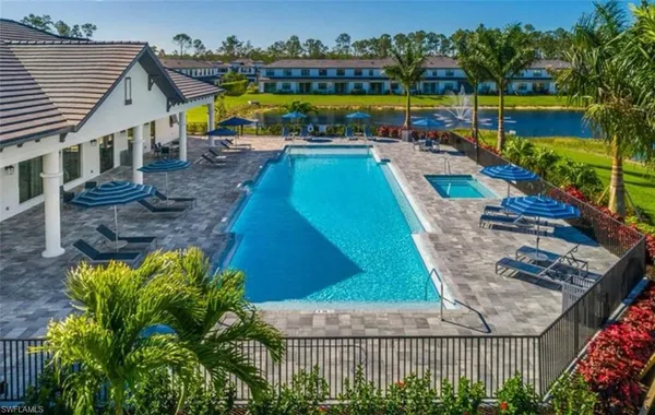 an aerial view of a house with a swimming pool patio and outdoor seating