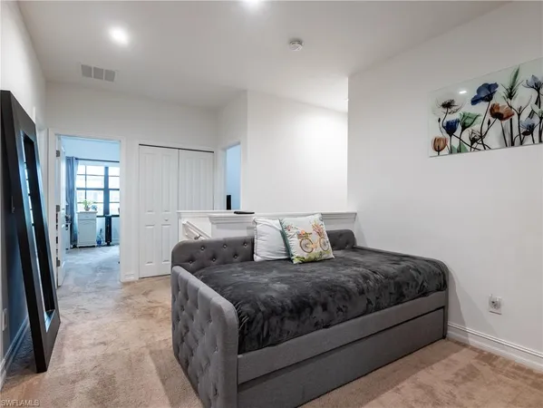 a living room with furniture a large window and a dining table
