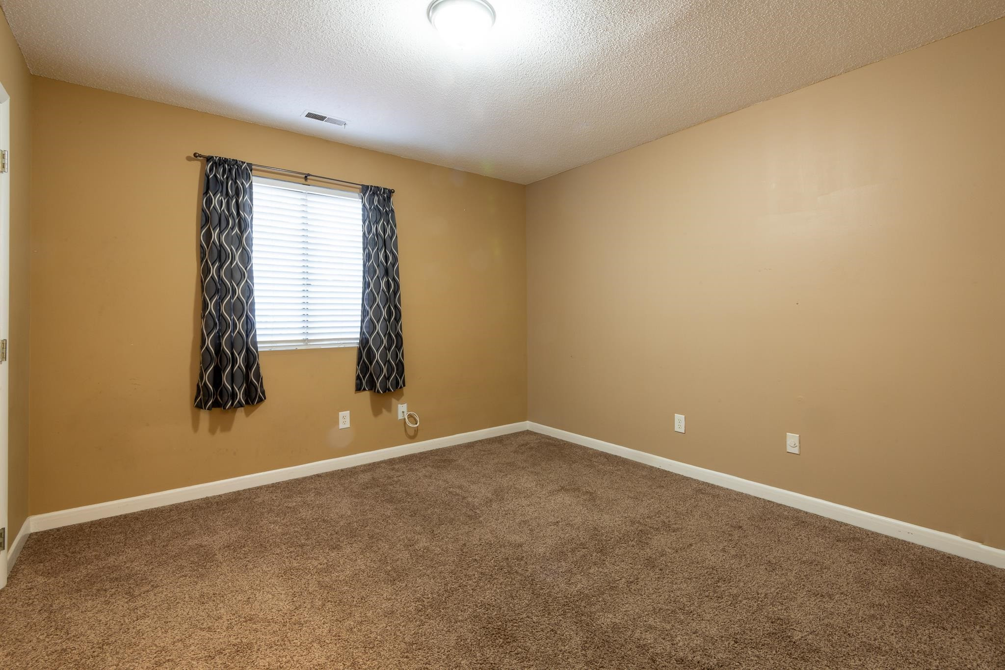 2160 Spring Forest Road, Unit 2160 Raleigh, NC 27615 - Photo 9 of 16 an empty room with windows