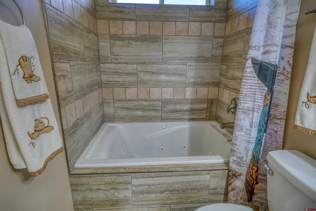 a bedroom with a bed and flat screen tv