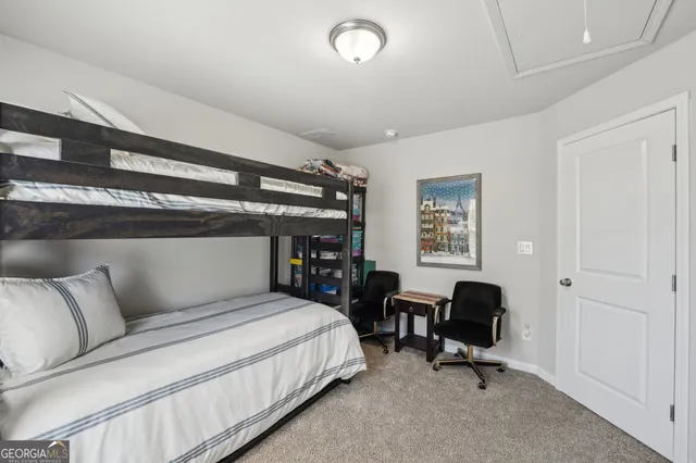 a bedroom with a bed a desk and chair