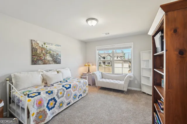 a bedroom with furniture and a large window