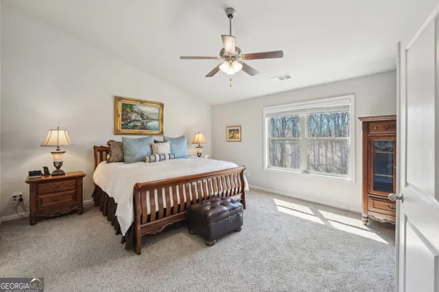 a spacious bedroom with a bed and a window