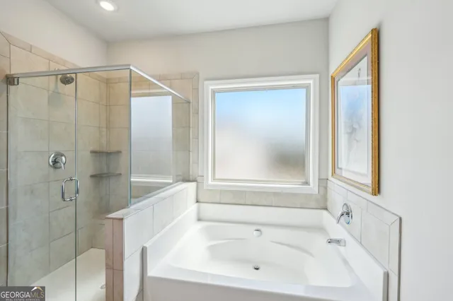 a bathroom with a bathtub and a shower