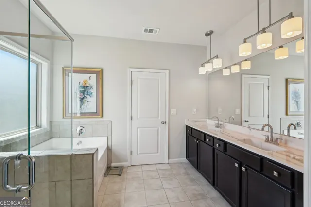 a spacious bathroom with a double vanity sink mirror and double