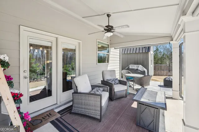 a view of a porch with furniture and a yard