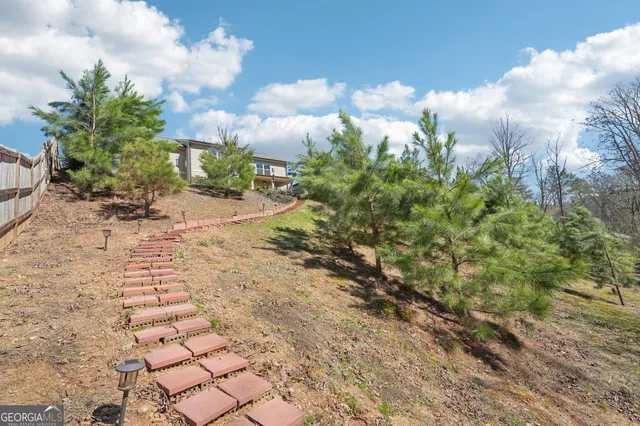 a view of a house with a yard and sitting area