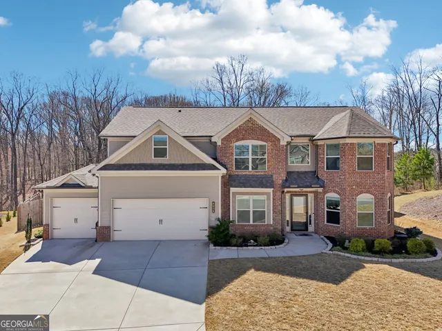 a aerial view of a house with a yard basket ball court and outdoor seating