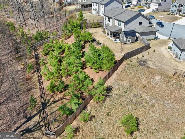 an aerial view of residential houses with outdoor space