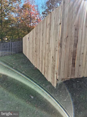 a view of a backyard with wooden fence