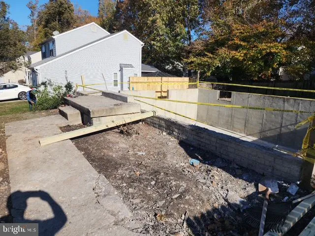 a view of a back yard of the house and a car parked