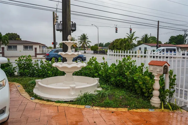 a view of a patio with plants and chairs