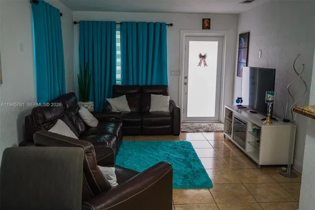 a living room with furniture and a yard