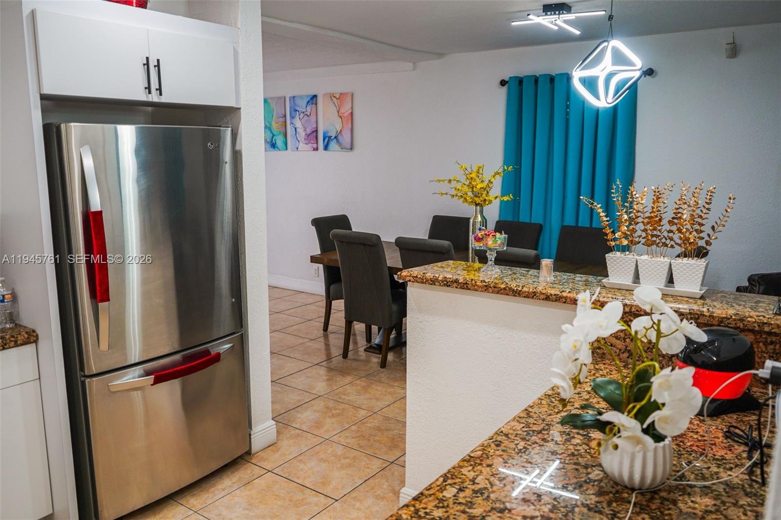 1190 West 33rd Street Hialeah, FL 33012 - Photo 18 of 54 a kitchen with stainless steel appliances granite countertop a refrigerator and a stove