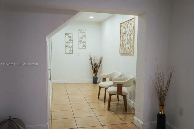 a living room with furniture and a chair