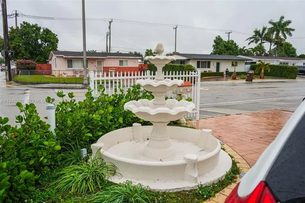 a view of a house with a sink and table in patio