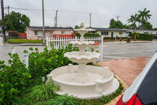 a view of a house with a sink and table in patio