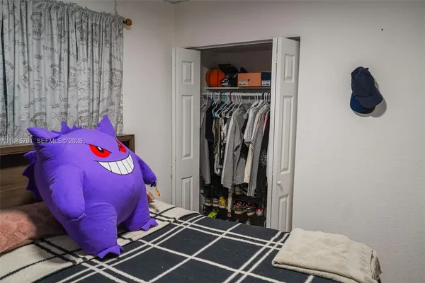 a bed sitting in a bedroom next to a window