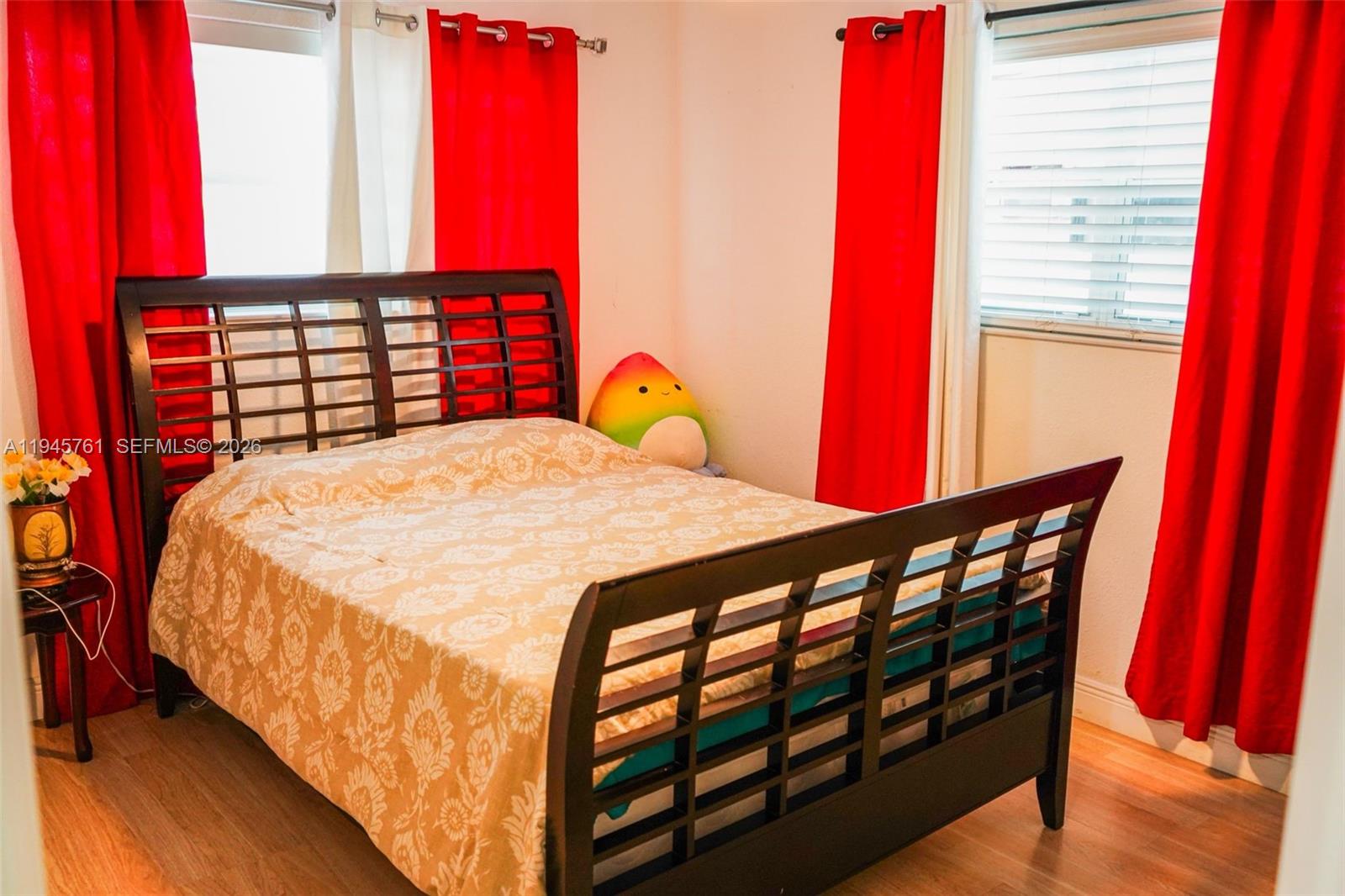 1190 West 33rd Street Hialeah, FL 33012 - Photo 29 of 54 a bedroom with a bed a dresser and a large window