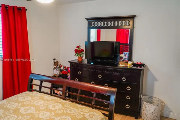 a bed room with a bed and a flat screen tv