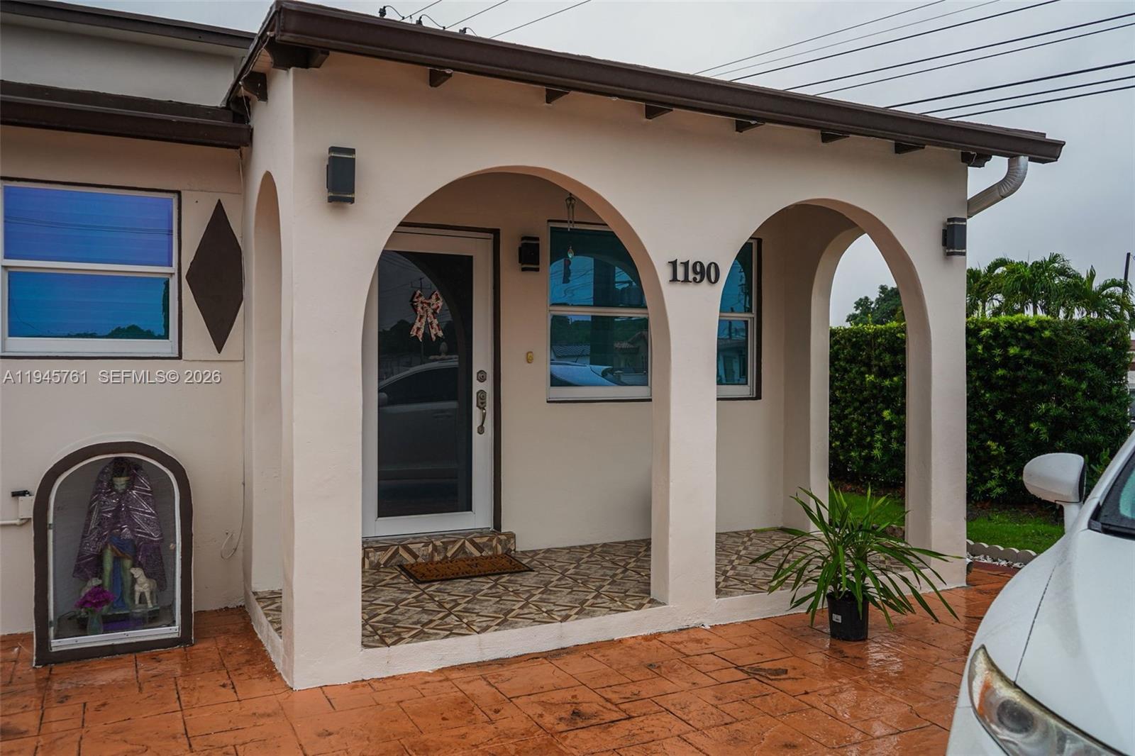 1190 West 33rd Street Hialeah, FL 33012 - Photo 3 of 54 a front view of a house with garden