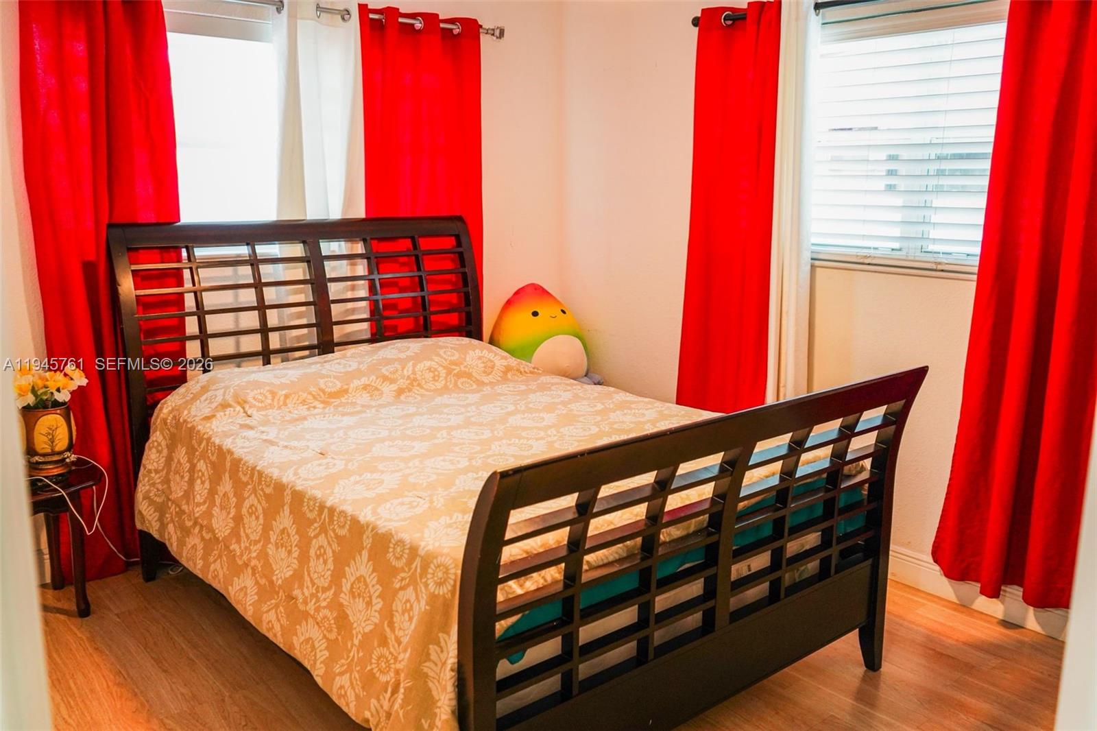 1190 West 33rd Street Hialeah, FL 33012 - Photo 32 of 54 a bedroom with a bed a dresser next to a window