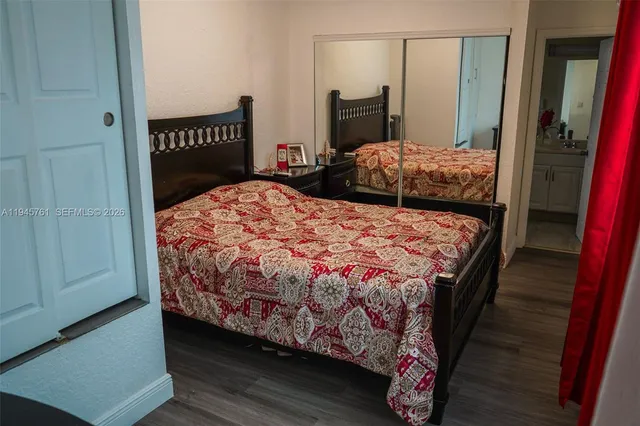 a bedroom with a bed and a dresser in it
