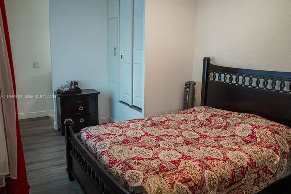 a bed sitting in a bedroom next to a window