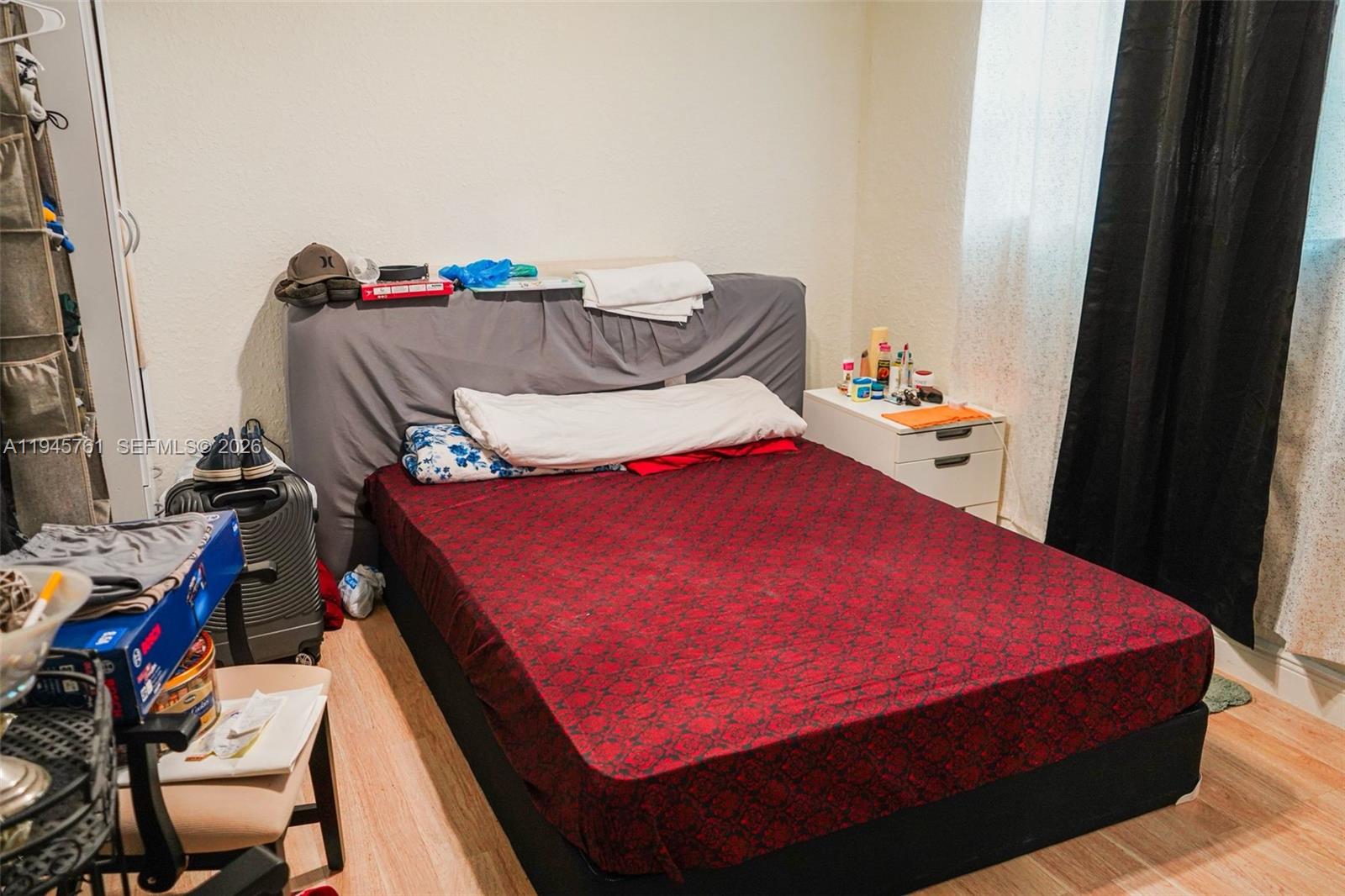 1190 West 33rd Street Hialeah, FL 33012 - Photo 38 of 54 a bed sitting in a bedroom next to a window