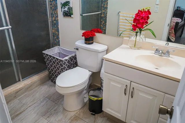 a bathroom with a sink toilet and shower