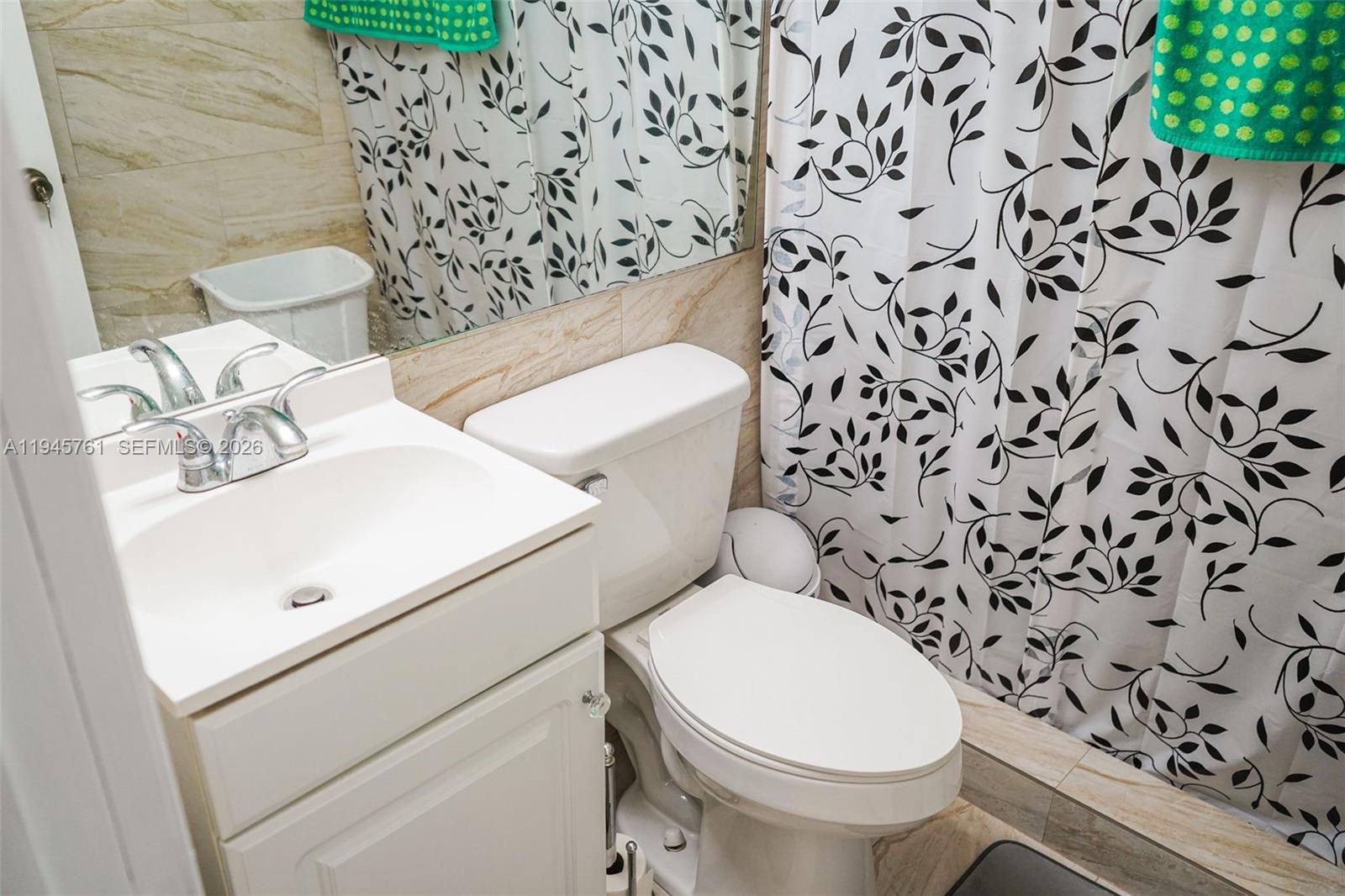 1190 West 33rd Street Hialeah, FL 33012 - Photo 45 of 54 a white toilet sitting next to a bathroom sink