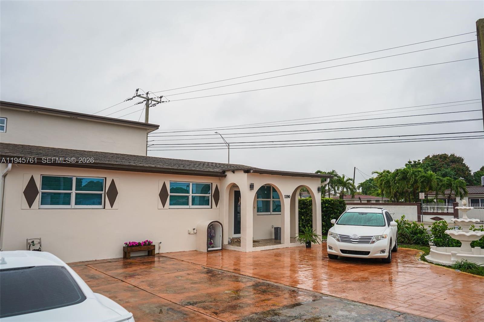 1190 West 33rd Street Hialeah, FL 33012 - Photo 6 of 54 a front view of a house with a garden