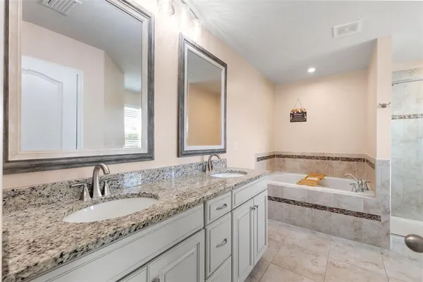 a bathroom with a tub and shower
