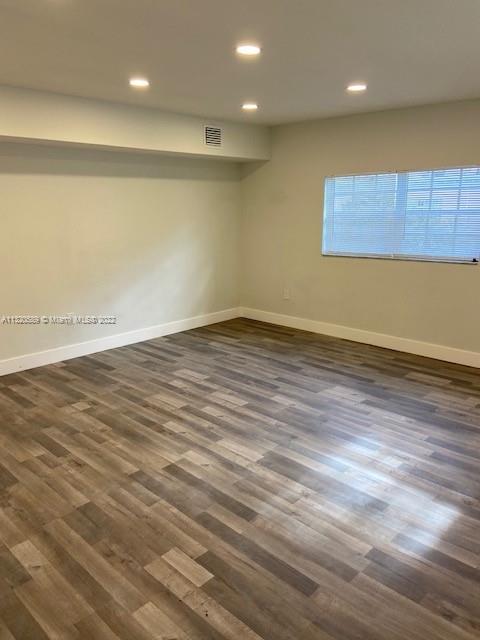 Biscayne Gardens Miami, FL 33169 - Photo 11 of 18 an empty room with wooden floor and a window