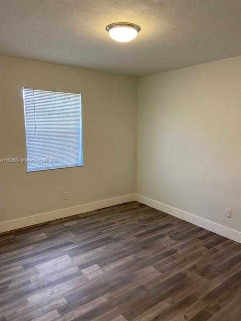 Biscayne Gardens Miami, FL 33169 - Photo 14 of 18 a view of an empty room with wooden floor and a window