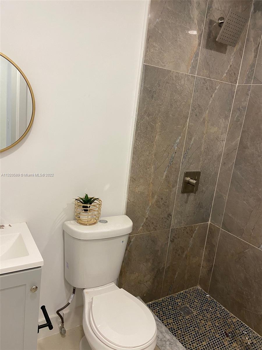 Biscayne Gardens Miami, FL 33169 - Photo 17 of 18 a white toilet sitting next to a bathroom sink