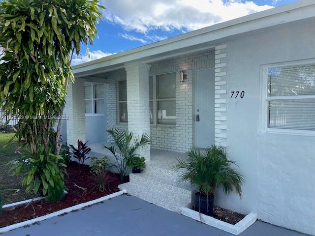 Biscayne Gardens Miami, FL 33169 - Photo 2 of 18 a potted plant sitting in front of a house